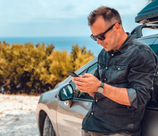 guy beside a car image